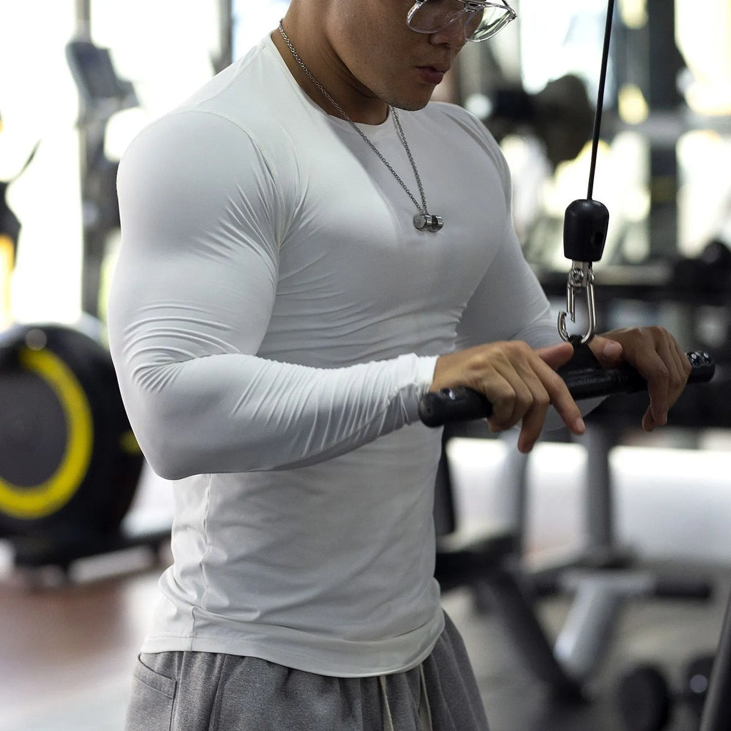 Men's black slim fit fitness tights with long sleeves for running and gym workouts.