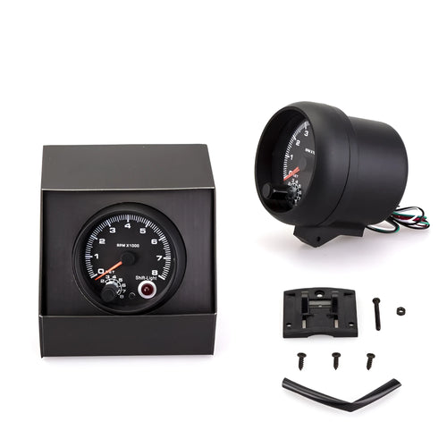 Black plastic automotive tachometer with blue-lit dial showing 0-8000 RPM scale.