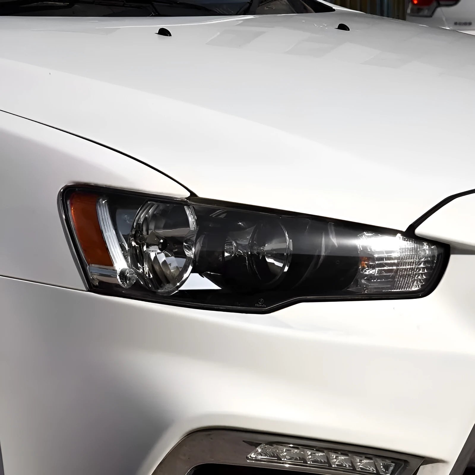 Transparent plastic headlight housing cover for vehicle lighting protection