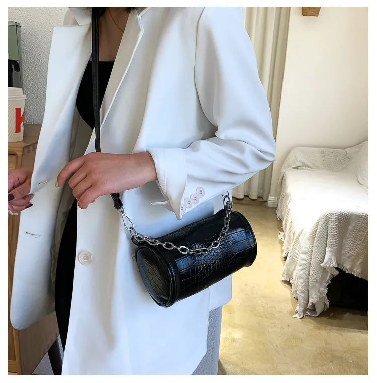 One shoulder cylinder messenger bag in beige PU leather with embossed crocodile pattern and zipper closure