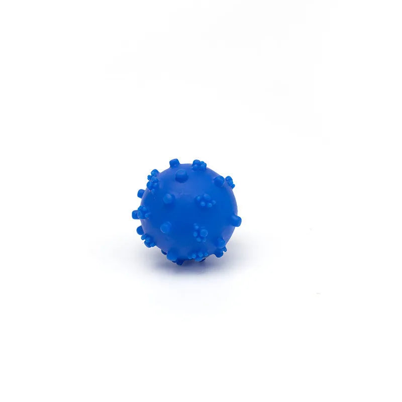 Bright blue, green, pink, and yellow spiked dog balls with paw print dimples on a white background.