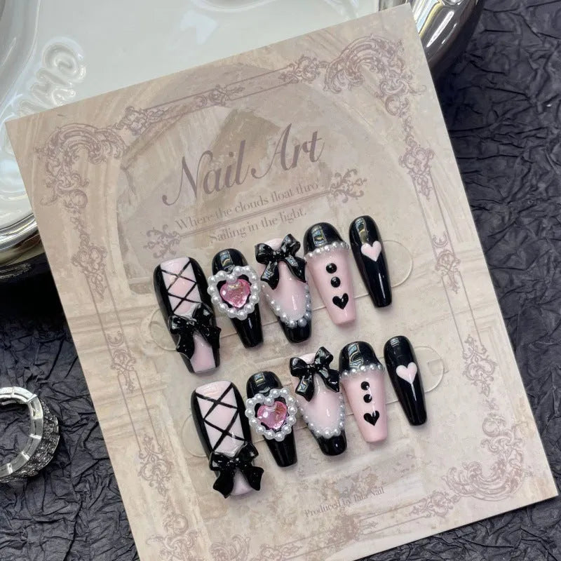Black pink heart shape hand-painted false nails with bow designs in plastic armour suit