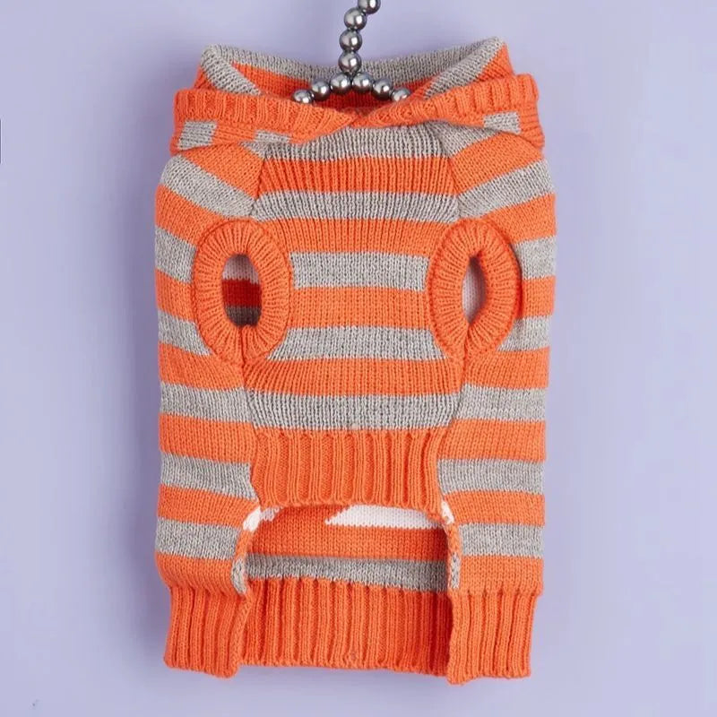 Orange knitted hooded pet sweater with striped pattern and fur balls for Halloween