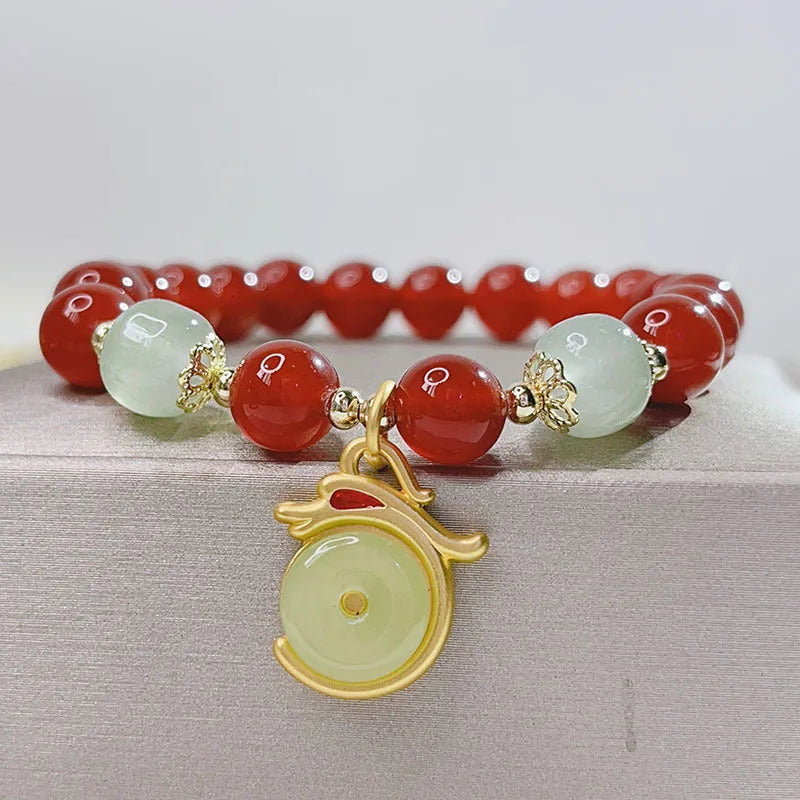 Handcrafted red agate bracelet with Chinese Dragon and Lucky Bag festival motifs