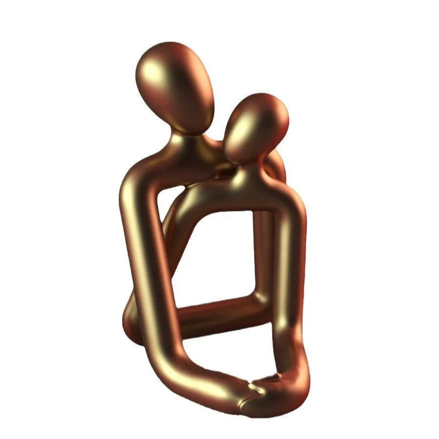 Modern couple resin statue in milky white or gold colour on a desk or shelf
