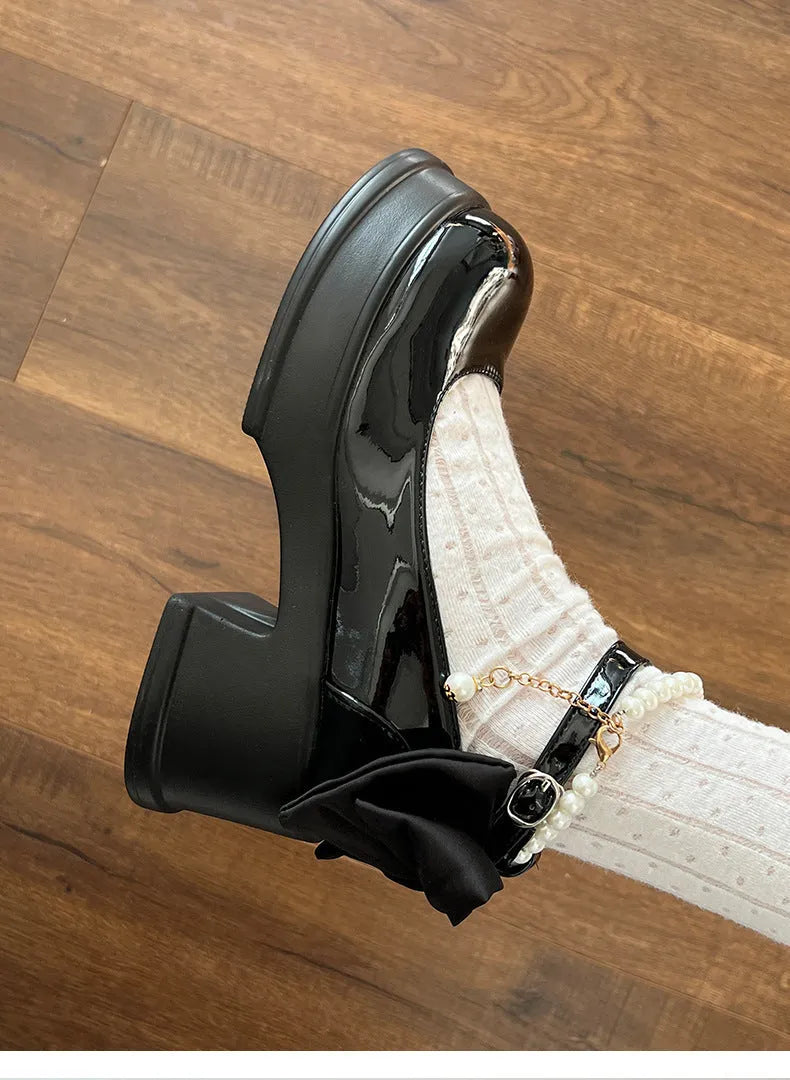 Beige and black women's Mary Jane pumps with a round toe and chunky heel.